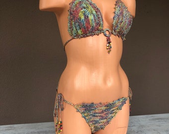 May include: A multi-colored crochet bikini top and bottom with beaded ties. The bikini is made of a soft, stretchy yarn and has a bohemian style.