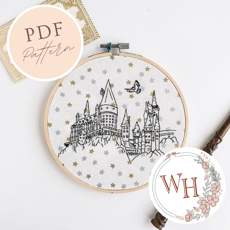 May include: A black and white embroidery hoop with a design of Hogwarts castle and stars. The hoop is on a white surface. The text "PDF Pattern" is on a pink circle in the upper left corner of the image.