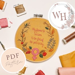 May include: A yellow embroidery hoop with a floral design and the text "My favourite season is the fall of the patriarchy". A pink female symbol is in the center of the hoop. The hoop is surrounded by embroidery floss, fabric scraps, and a PDF pattern.