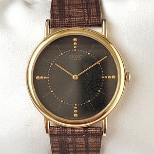 Reloj Seiko vintage negro y dorado de los años 90, único