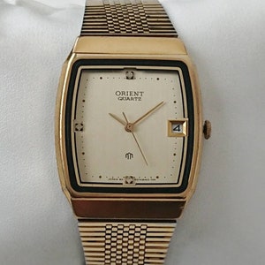 Reloj Orient vintage dorado con diamantes de los años 90, todo original.