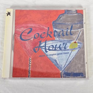 May include: A CD case with a red background and the words "Cocktail Hour" in blue script. The cover art features illustrations of cocktail glasses and a shaker. The text "music to inspire good times" is also present.
