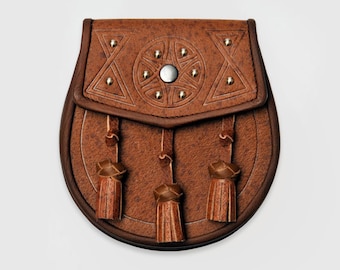 May include: A brown leather sporran with a Celtic knot design and three tassels. The sporran has a silver button and is decorated with metal studs.