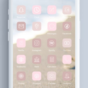 May include: A pink and white phone screen with app icons for popular social media, communication, and entertainment apps. The icons are arranged in a grid pattern and feature simple white outlines on a pink background.