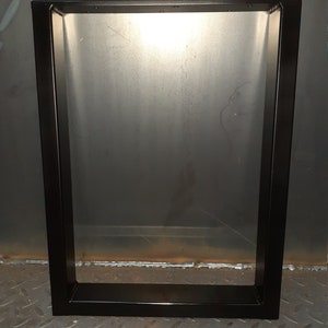 May include: Black metal table legs with a rectangular frame. The legs are welded together at the corners and have a smooth, matte finish.