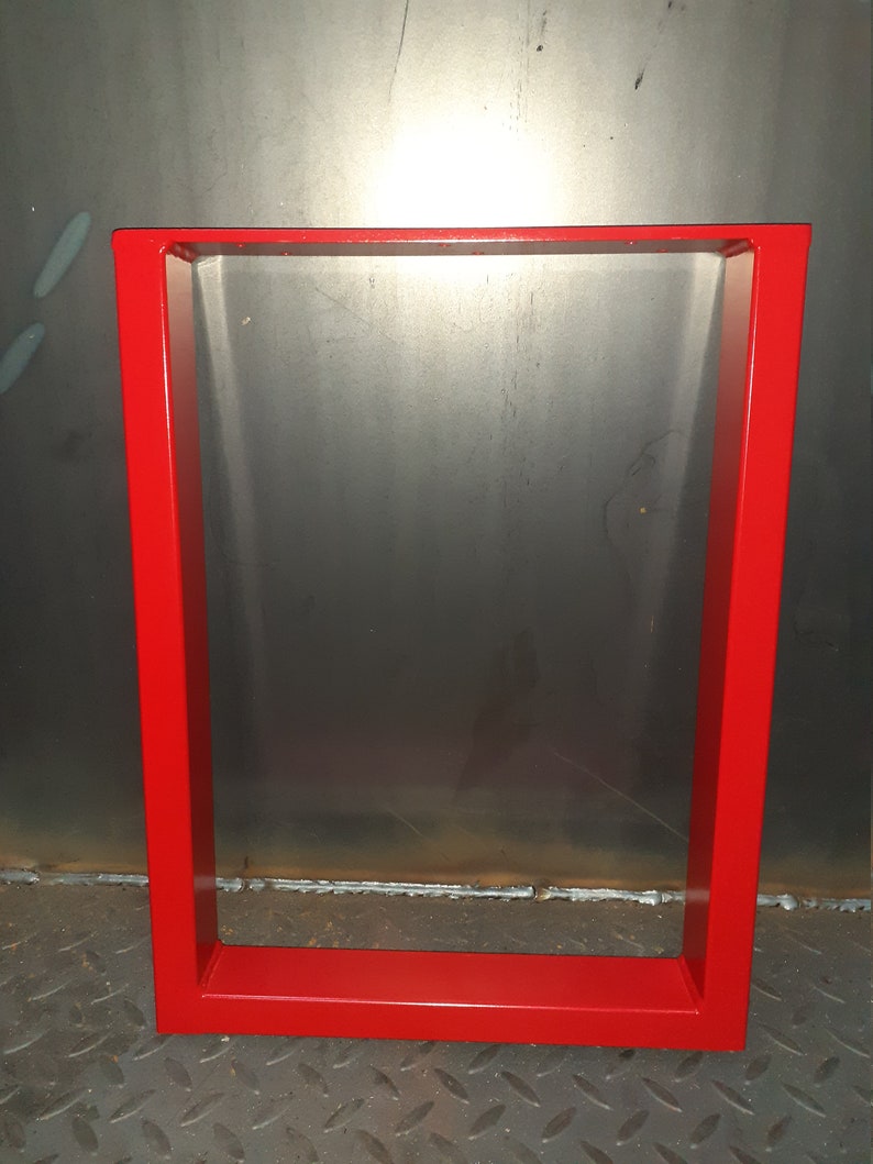 May include: Red metal table legs with a square frame. The legs are made of thick metal and have a smooth, painted finish.