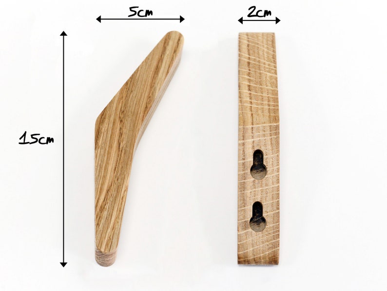 May include: A wooden wall hook with a curved design. It measures 5 inches wide, 1.5 inches tall, and 2 inches deep. The hook has two holes for mounting.