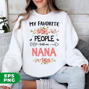 May include: White sweatshirt with pink floral design and the text "My Favorite People Call Me Nana".