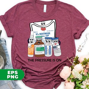 May include: A maroon t-shirt with a cartoon image of a medical IV bag and four vials of medication. The IV bag has a face and the vials have faces. The text "THE PRESSURE IS ON" is printed below the image.