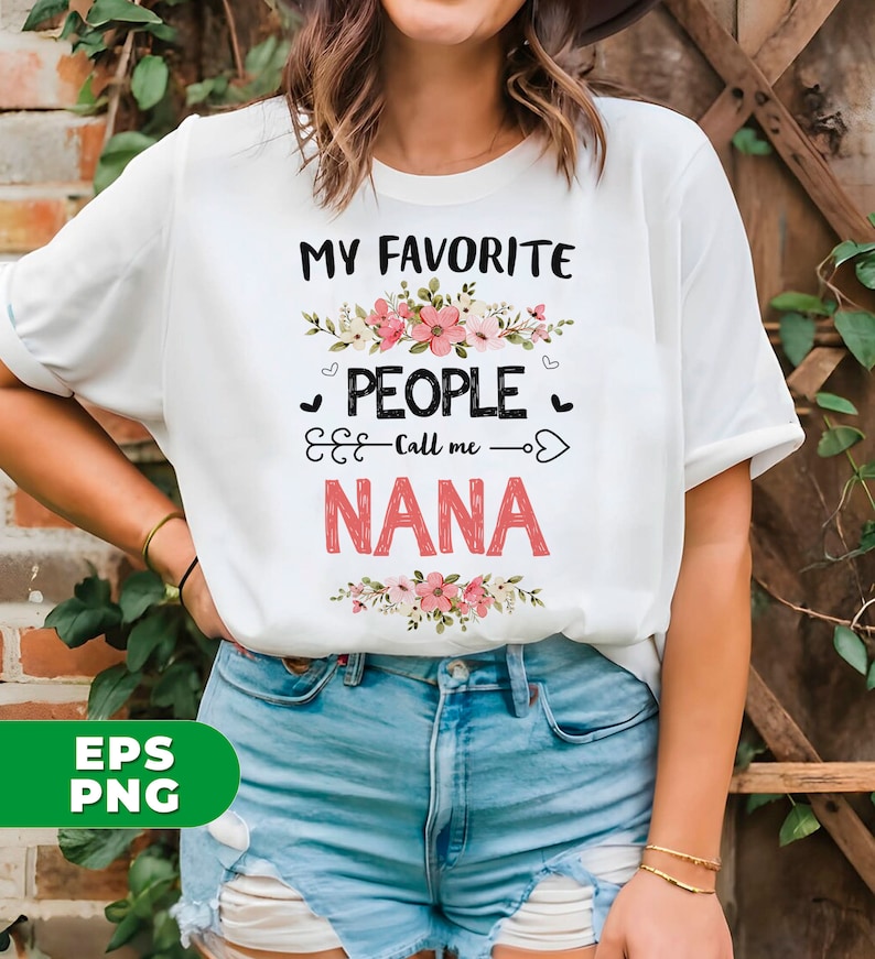 May include: White t-shirt with the text "My Favorite People Call Me Nana" in black with pink floral accents.