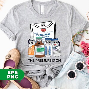 May include: A gray t-shirt with a graphic of a cartoon IV bag and four vials. The IV bag has a face and says "5% Dextrose Solution, USP". The vials also have faces and say "Epinephrine", "Levophed", "Vasopressin", and "NaCl Injection". The text "The Pressure Is On" is printed below the graphic.