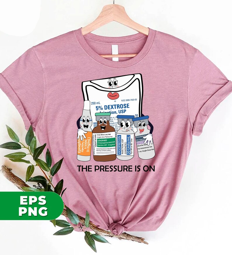 May include: A pink t-shirt with a graphic of a medical IV bag and several vials of medication. The IV bag has a face and the vials have faces. The text "THE PRESSURE IS ON" is printed below the graphic.