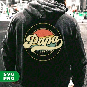 Puede incluir: Sudadera negra con un gr&aacute;fico retro de un sol con la palabra "Papa" en una fuente vintage.