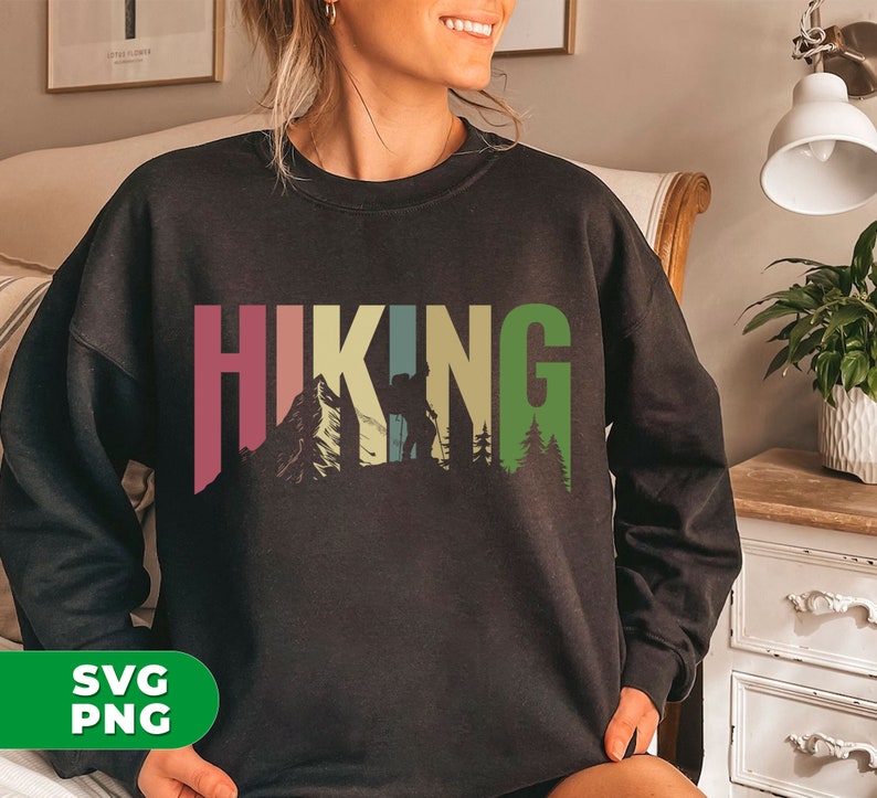 May include: Black sweatshirt with a colorful graphic design that says "HIKING" with a silhouette of a person hiking in the mountains.