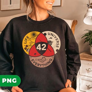 May include: Black crewneck sweatshirt featuring a Venn diagram design with the words "Life", "Universe", and "Everything". The number "42" is in the center. The design includes illustrations of a sun, a bat, and a fish.