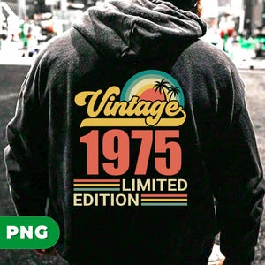 May include: Black hoodie with a retro design. The design features the word "Vintage" in yellow script above the number "1975" in orange, with "Limited Edition" below. A colorful sunset and palm trees complete the design.