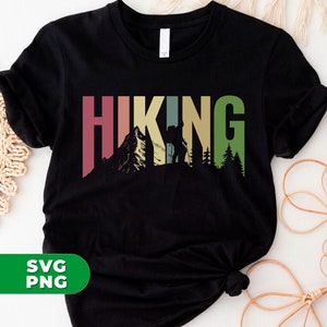 May include: Black t-shirt with a retro-style graphic of the word "HIKING" in colorful letters. A silhouette of a hiker with a backpack is in the middle of the word, with mountains and trees behind it.