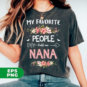 May include: A gray t-shirt with the text "My Favorite People Call Me Nana" in pink and white lettering. The text is surrounded by a floral design with pink and white flowers.
