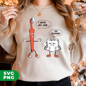 May include: A beige sweatshirt with a cartoon image of a toothbrush and a roll of toilet paper. The toothbrush is red and has a face with a surprised expression. The toilet paper has a face with a sad expression. The text on the sweatshirt reads "I hate my job... Oh please!"