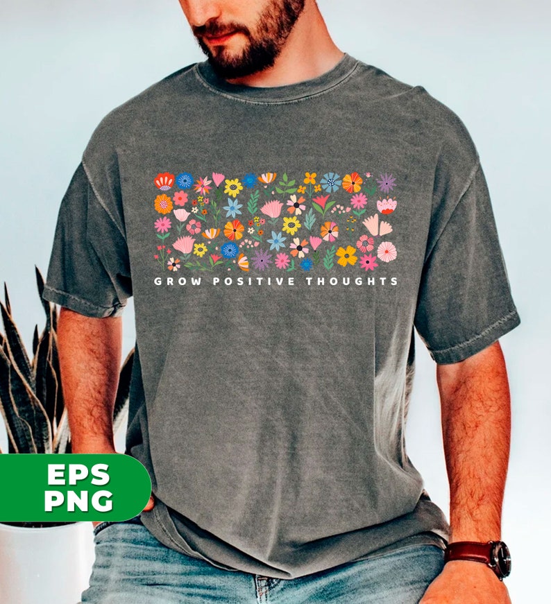 May include: A gray t-shirt with a colorful floral design and the text "GROW POSITIVE THOUGHTS" printed on the front.