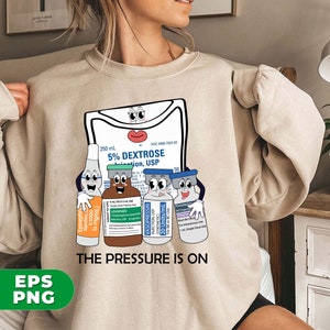 May include: A beige sweatshirt with a graphic of a cartoon IV bag and four vials of medication. The text "THE PRESSURE IS ON" is printed below the graphic.