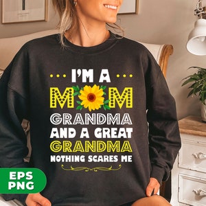 May include: Black sweatshirt with a white graphic print that says "... I'M A... MOM GRANDMA AND A GREAT GRANDMA NOTHING SCARES ME". The graphic also includes a yellow sunflower.