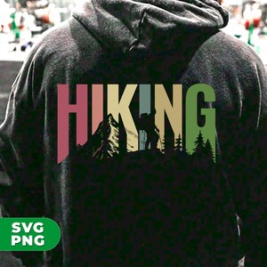 May include: A black hoodie with a vintage-style graphic of a hiker in a mountain landscape. The graphic says "HIKING" in colorful letters.