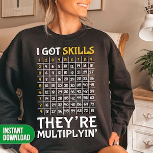 May include: Black sweatshirt with the text "I GOT SKILLS" and a multiplication table. The text "THEY'RE MULTIPLYIN'" is below the table.