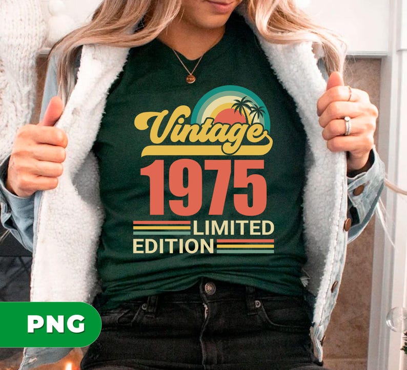 May include: Dark green t-shirt with a retro design that reads "Vintage 1975 Limited Edition." The design features a sunset with palm trees and a rainbow. The text is in yellow and orange.