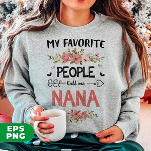 May include: Gray sweatshirt with the text "My Favorite People Call Me Nana" in black and pink lettering. The text is surrounded by a floral design with pink and white flowers.