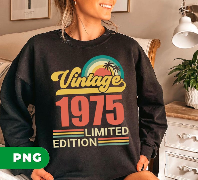 May include: Black sweatshirt with a retro design. The design features the text "Vintage 1975 Limited Edition" in yellow, red, and green. A colorful sunset and palm trees are also included in the design.