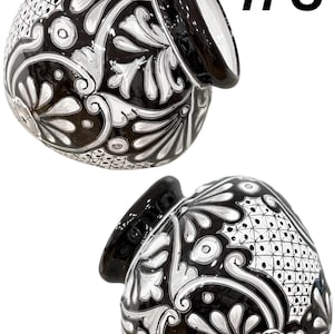 May include: Two black ceramic vases with white floral designs. The vases are hand-painted and have a glossy finish. The vase on the left is tilted to the side, while the vase on the right is upright. The text #3 is visible in the top right corner of the image.