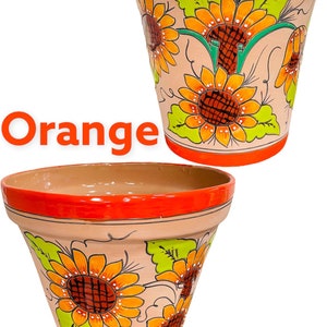 May include: Two terracotta flower pots with orange rims and bases. The pots are decorated with orange and yellow sunflowers and green leaves. The word "Orange" is written in orange on the image.