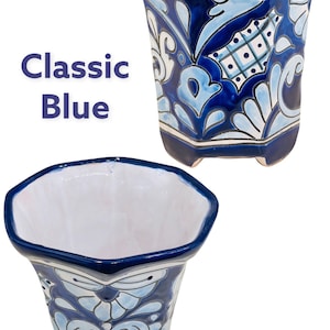May include: A blue and white ceramic planter with a geometric design. The planter has a classic blue and white color scheme and a unique octagonal shape.