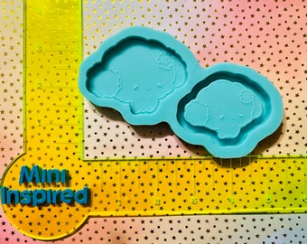 May include: Two blue silicone molds for making resin crafts. Each mold features a cartoon character with a bow and a closed eye.