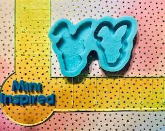 May include: Two blue silicone molds for making resin crafts. Each mold features a bunny rabbit design with a detailed face and ears.