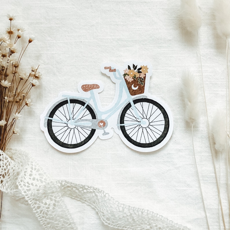 May include: A light blue bicycle with a basket of flowers on the handlebars. The bicycle has a white background and is on a white surface.
