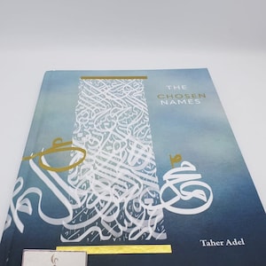 May include: A blue hardcover book with a gold title, "The Chosen Names" by Taher Adel. The cover features intricate white Arabic calligraphy on a blue and white watercolor background.