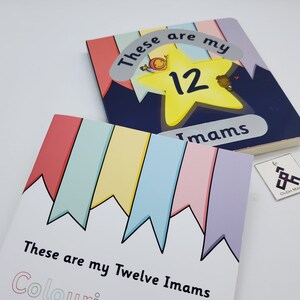 May include: A coloring book with a white cover and colorful flags on the top. The title is "These are my Twelve Imams Coloring Book".