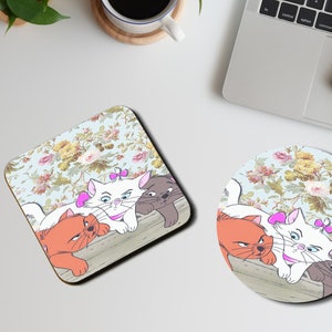 May include: Four cartoon cats, two orange, one white, and one gray, are lying on a floral patterned surface. The white cat has a pink bow on its head. The cats are looking at the viewer. The background is a light blue with a floral pattern.