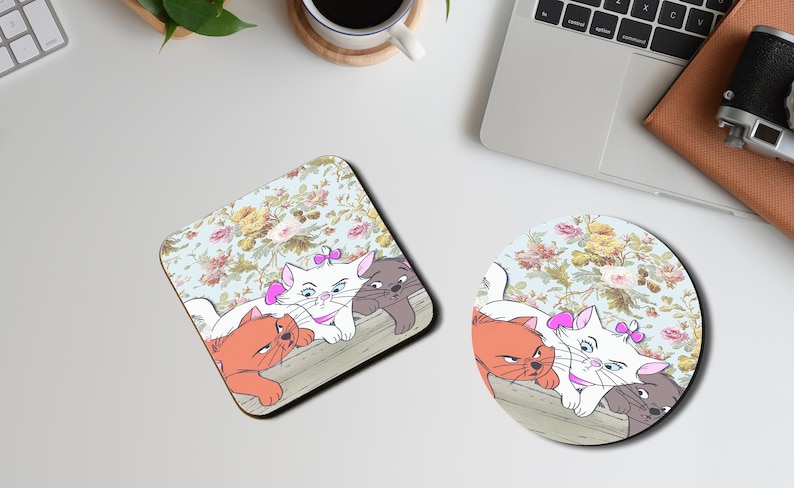 May include: Four cartoon cats, two orange, one white, and one gray, are lying on a floral patterned surface. The white cat has a pink bow on its head. The cats are looking at the viewer. The background is a light blue with a floral pattern.