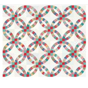 May include: A colorful quilt featuring a double wedding ring pattern. The design incorporates various patterned fabric squares in a circular arrangement, with red and teal accents. The background is a light, dotted fabric.