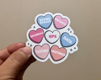 Könnte beinhalten: Ein Set aus sieben herzförmigen Aufklebern in verschiedenen Farben mit Text. Der Text auf den Aufklebern lautet "Bewertungsskalen", "Berichte", "Überweisungen", "IEPs", "Daten", "Tests" und "Meetings".
