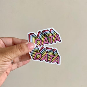 May include: Two rainbow colored stickers with the word "DATA" in pink letters. The stickers are layered on top of each other.