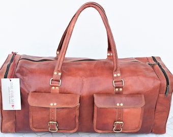 May include: A brown leather duffel bag with two front pockets and a zipper closure. The bag has a leather handle and a tag that says "The Fur Shop".