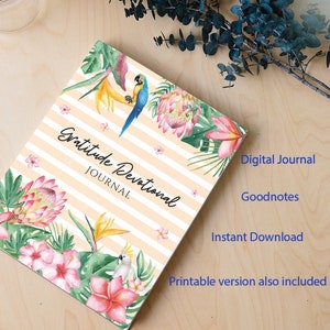 May include: A digital journal cover with a tropical theme. The cover features a pink and white hibiscus flower, green leaves, a yellow bird, and a blue parrot. The text "Gratitude Devotional Journal" is written in a white cursive font.