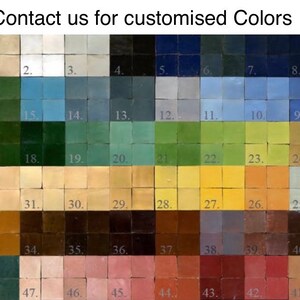 May include: A color chart with 48 small square tiles, each a different shade of color. The tiles are arranged in rows and columns, and each tile is numbered. The colors range from light to dark, and include shades of blue, green, yellow, brown, and red.