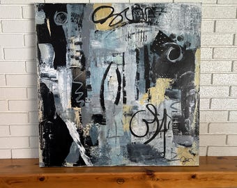 May include: Abstract painting on canvas with black, white, gray, and gold paint. The painting has a textured surface and features geometric shapes and lines. The artist's signature is visible in the bottom right corner.