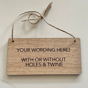 May include: A wooden sign with the text "YOUR WORDING HERE! WITH OR WITHOUT HOLES & TWINE" engraved on it. The sign is hanging from a piece of twine.