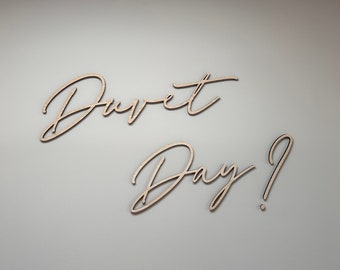 May include: Wooden wall decor with the words "Donut Day?" in cursive script.